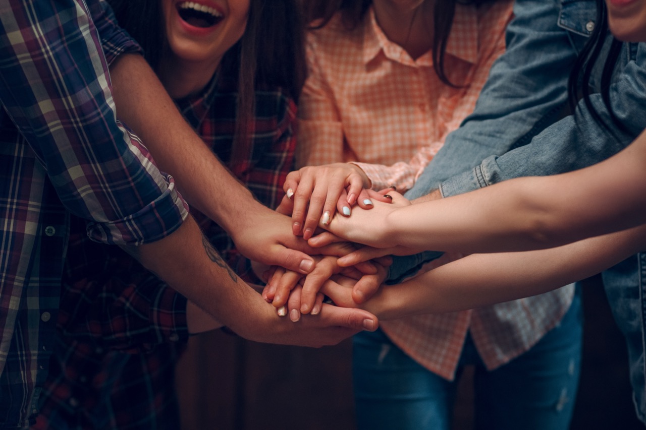 Community team with hands together in unity