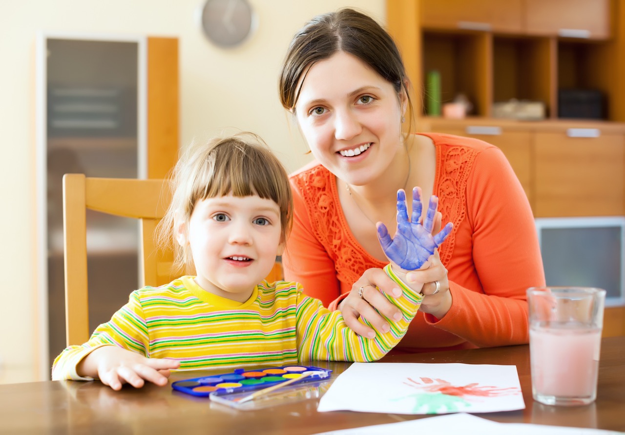 Teacher supporting a young learner during a creative session